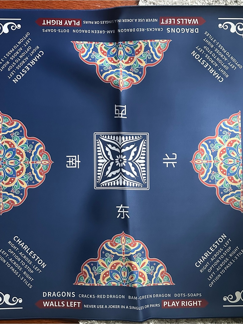 Blue American Mahjong mat with printed rules.